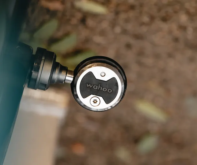 A close-up of a Wahoo POWRLINK power pedal mounted on a bike